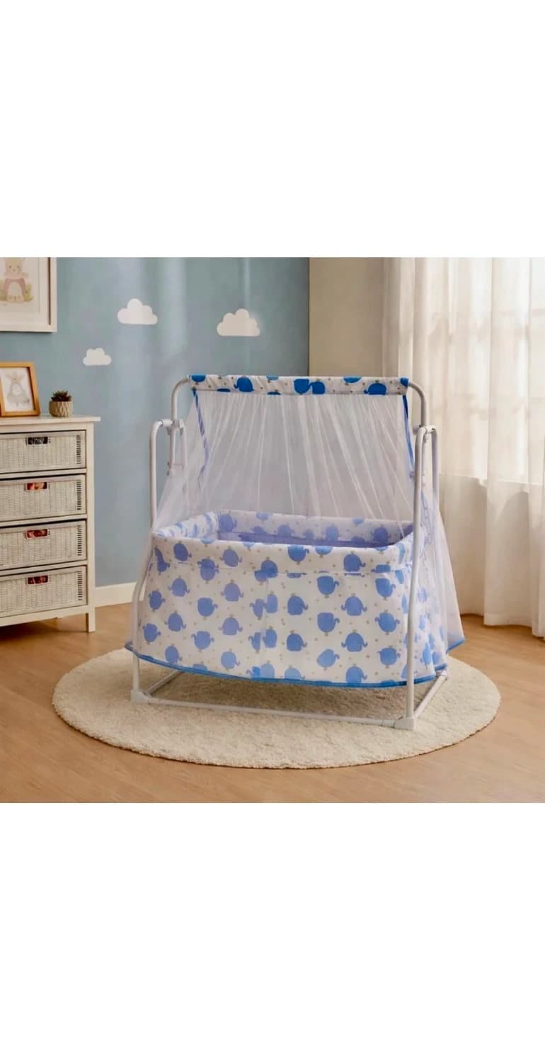 Blue whale print baby cradle with white frame and net canopy